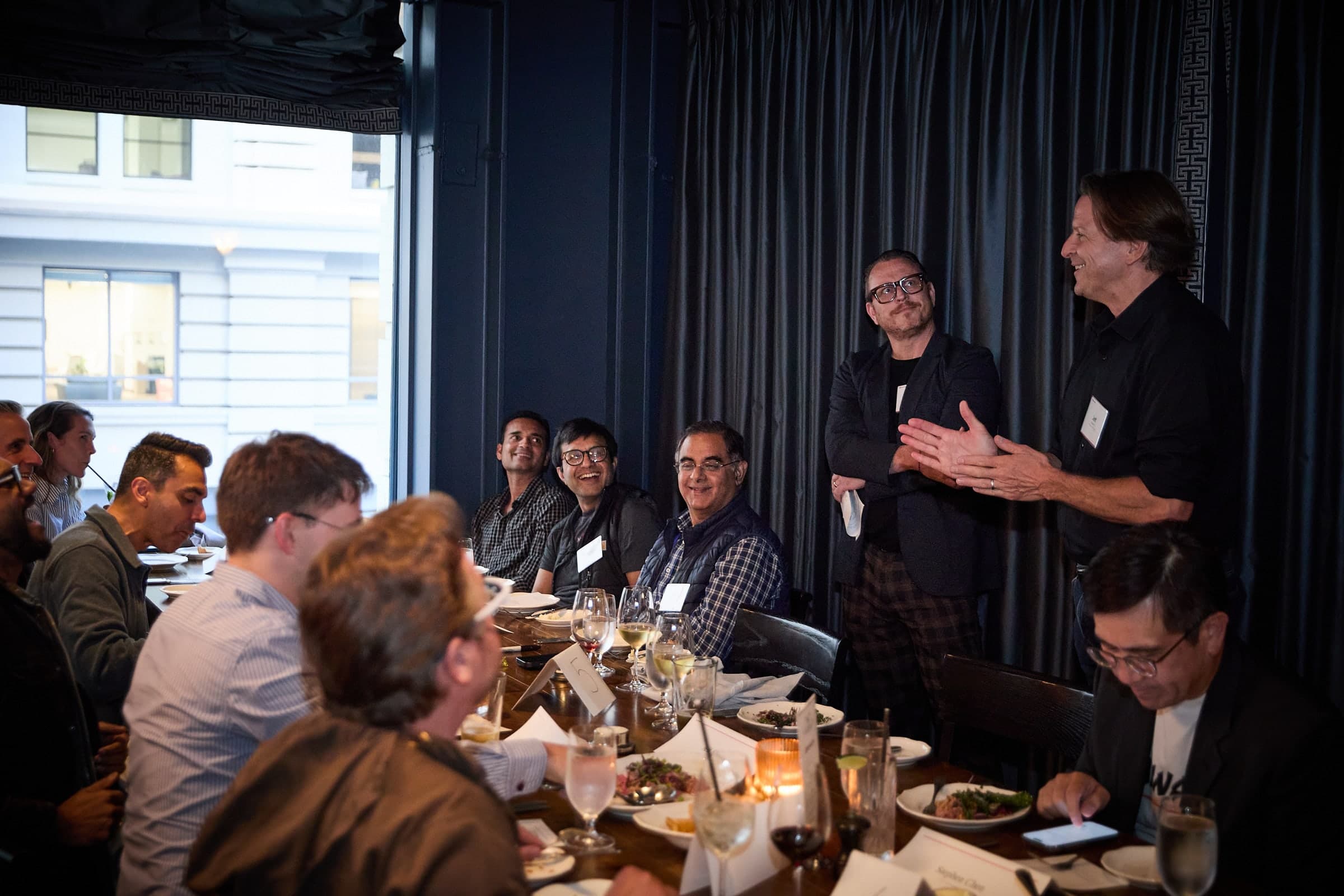 The hosts holding the room at a Tech Leaders dinner